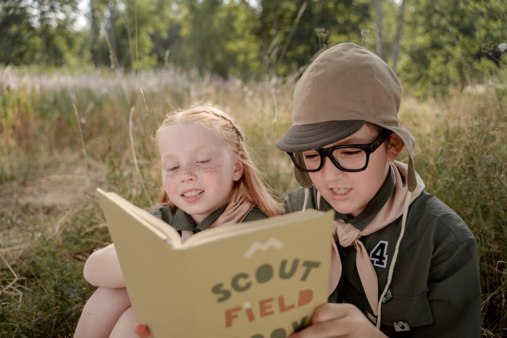 a girl and boy reading a book